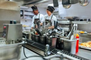 Commercial kitchen with cooking team at work