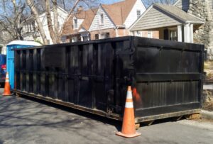 Roll-off dumpster in front of residential home