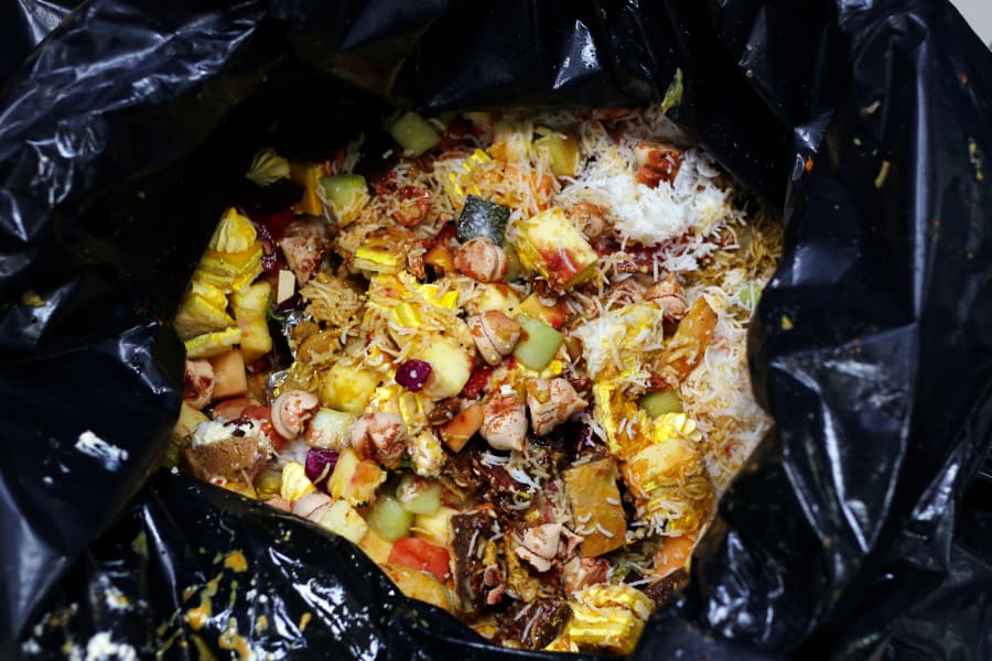 Food waste inside black garbage bag ready for disposal