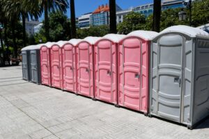 Row of colorful portable toilets in park